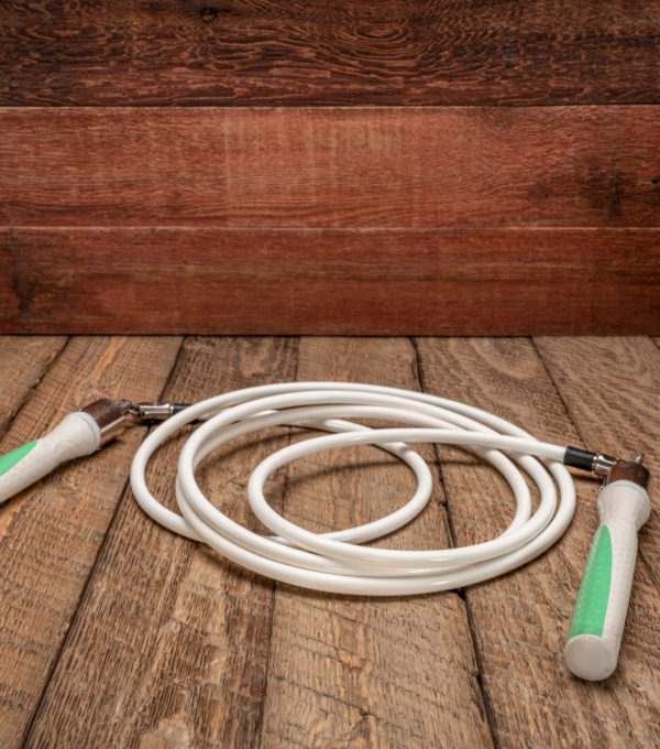 heavy fitness jump rope on rustic, weathered wood background